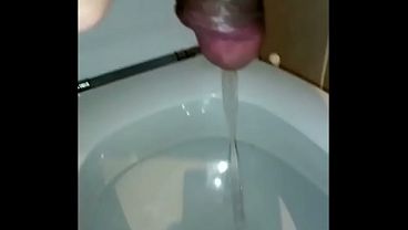 Cock urinating wearing women s clothing and with painted nails