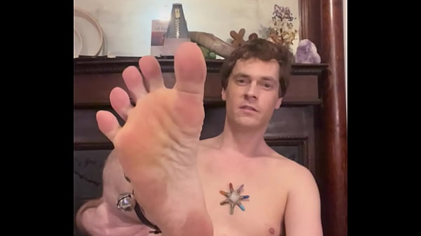 Daniel sticks his foot at the camera and shakes his bells