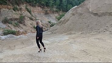 Grandma is walking around a gravel pit in tight leggings and high heels!