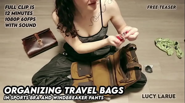 Organizing Travel Bags In Sports Bra And Windbreaker Pants thumbnail