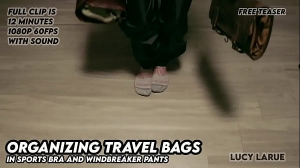 Organizing Travel Bags in Sports Bra and Windbreaker Pants