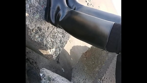 Fetish rubber boots at beach 