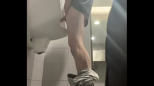2 Boys In Sneakers Having Fun At Public Toilets' Urinal thumbnail